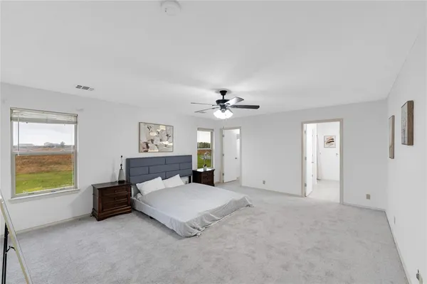 a spacious bedroom with a bed and a table