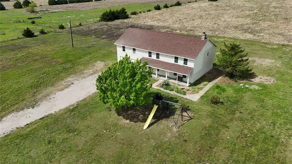 an aerial view of a house with a yard