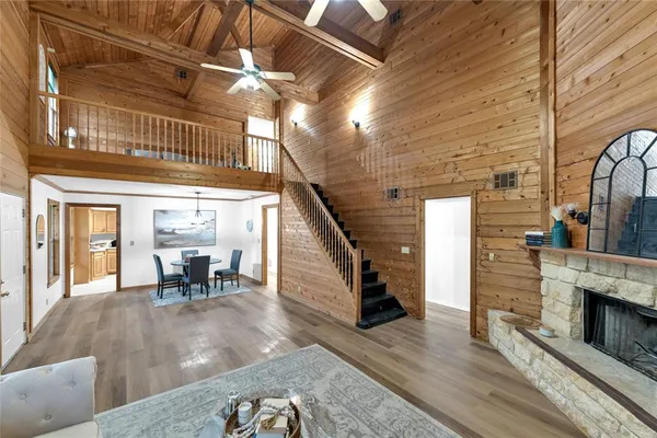 a dining room with furniture entryway and wooden floor