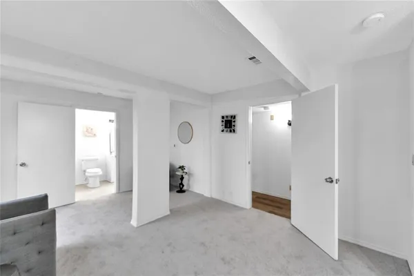 an empty room with closet and wooden door