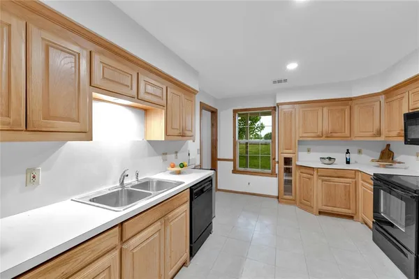 a kitchen with a sink stove top oven and refrigerator