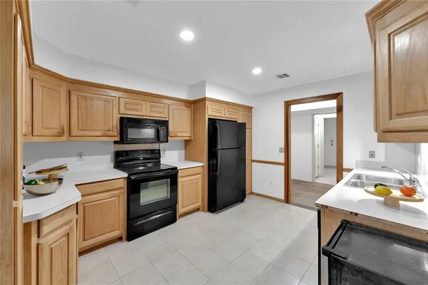 a kitchen with stainless steel appliances a stove refrigerator sink and microwave