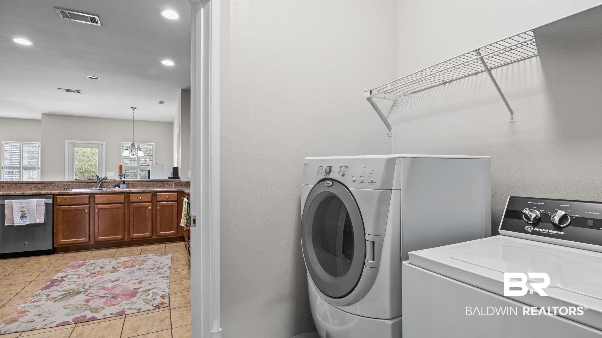 1090 Melbourne Court Foley, AL 36535 - Photo 30 of 38 Laundry room with washing machine and clothes dryer, a chandelier, and light tile patterned floors