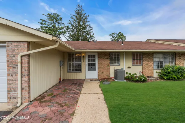 a front view of a house with a garden and yard