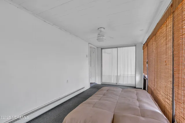 a view of room with hardwood floor and hallway