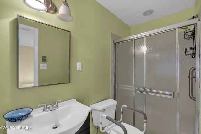 a bathroom with a sink mirror and toilet