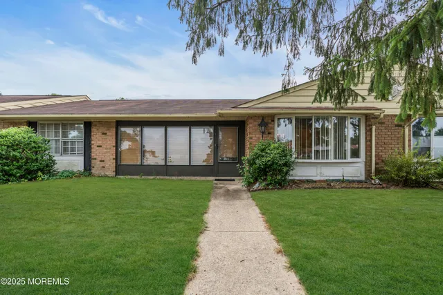 a front view of a house with a garden