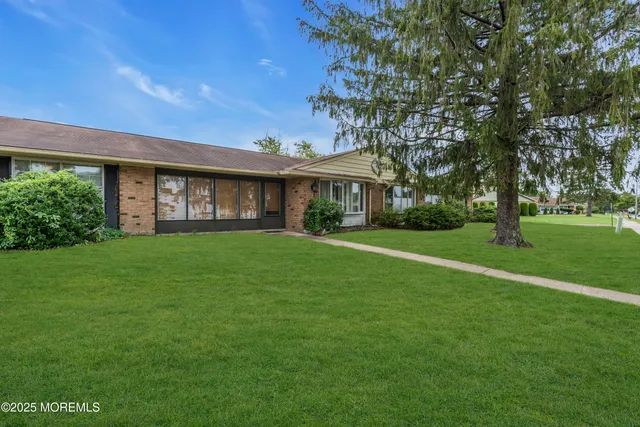 a front view of house with yard and green space