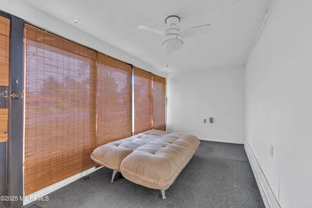 a large bed sitting in a room next to a window