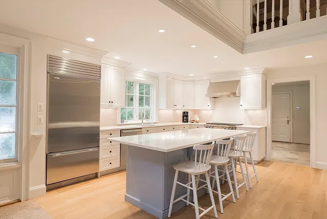 a kitchen with stainless steel appliances granite countertop a stove and a refrigerator