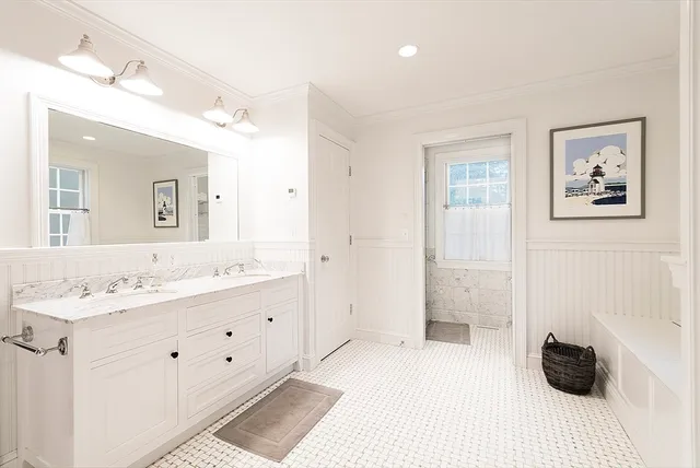 a spacious bathroom with a double vanity sink and a mirror
