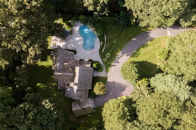 an aerial view of a house with a yard and lake view