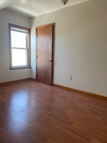 52 Forest Street, Unit 3 Fall River, MA 02721 - Photo 3 of 10 an empty room with wooden floor and windows