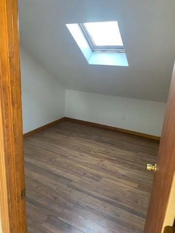 52 Forest Street, Unit 3 Fall River, MA 02721 - Photo 4 of 10 an empty room with wooden floor and windows