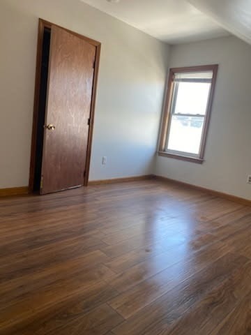 52 Forest Street, Unit 3 Fall River, MA 02721 - Photo 7 of 10 an empty room with wooden floor and windows