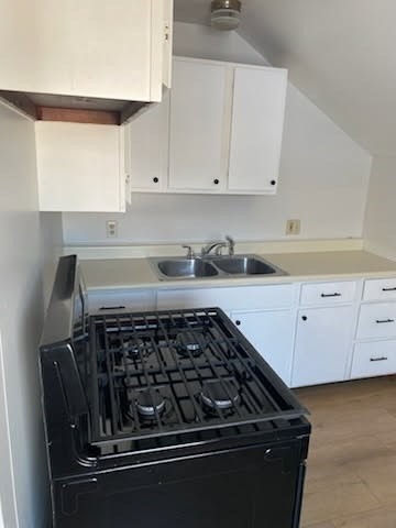 52 Forest Street, Unit 3 Fall River, MA 02721 - Photo 8 of 10 a kitchen with white cabinets and appliances