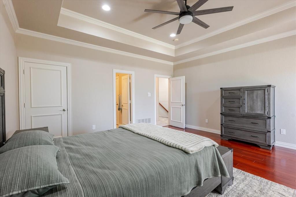 166 East Rio Ridge Azle, TX 76020 - Photo 25 of 40 a bedroom with a bed and wooden floor
