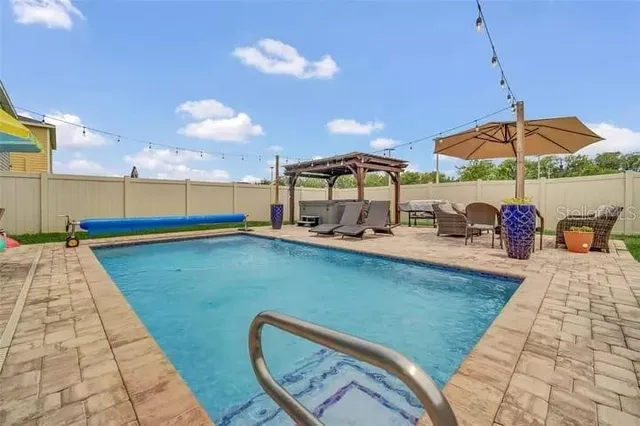 a view of a swimming pool with a patio