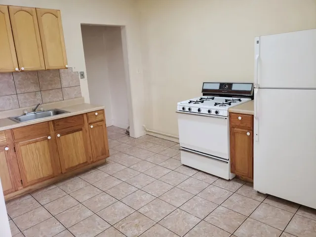 a kitchen with stainless steel appliances a stove a refrigerator and a sink
