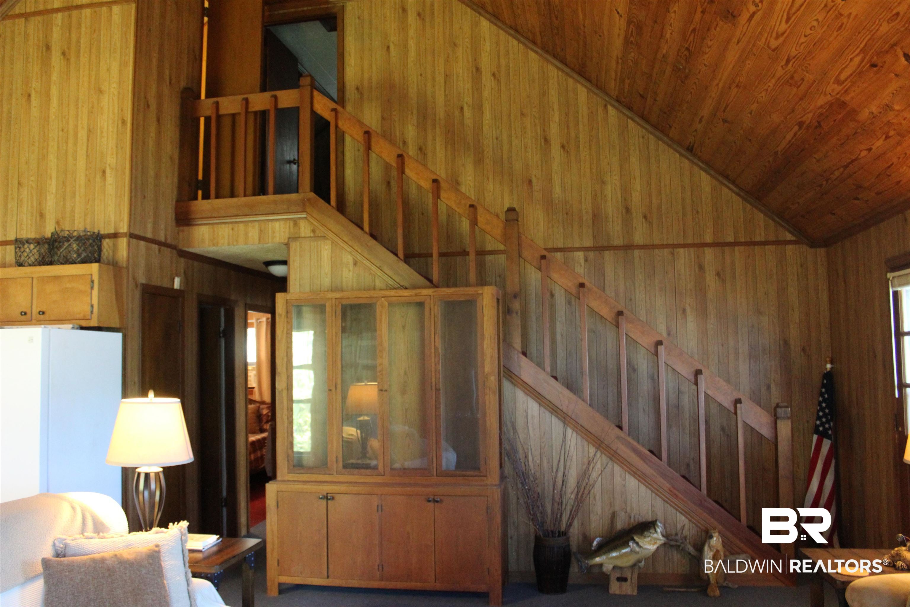 6447 Henderson Road Lowndesboro, AL 36752 - Photo 18 of 22 Living room with vaulted ceiling and wood walls