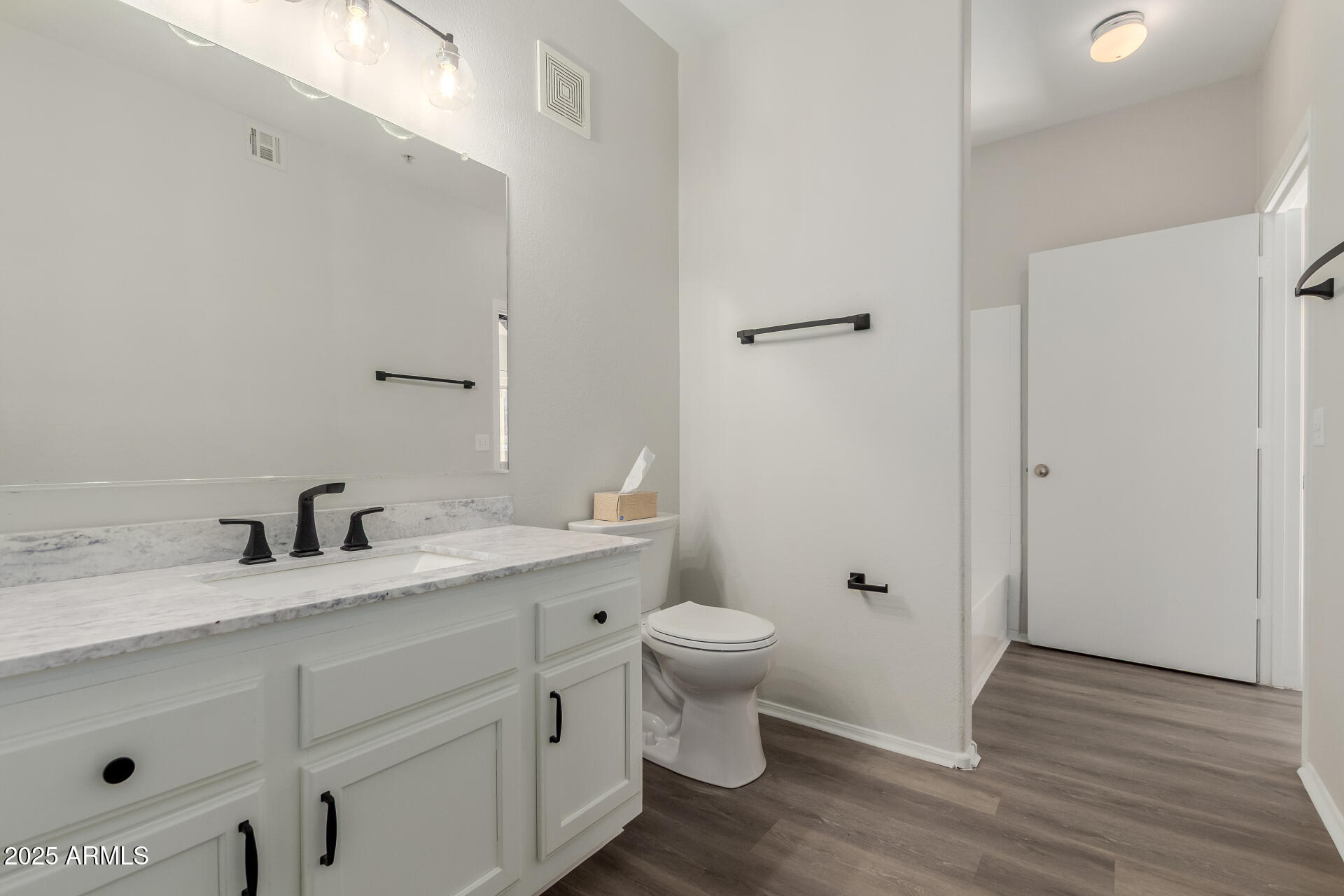 4644 North 22nd Street, Unit 1161 Phoenix, AZ 85016 - Photo 13 of 25 a bathroom with a granite countertop toilet sink and a mirror