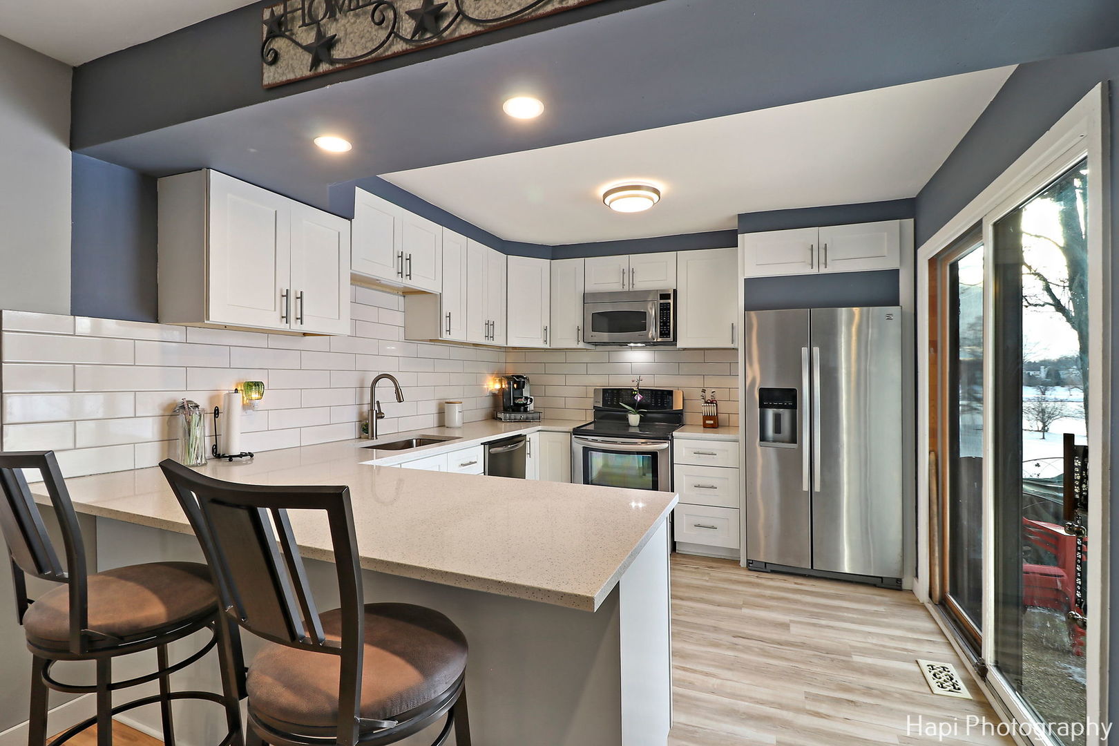 734 Chandler Road Gurnee, IL 60031 - Photo 6 of 26 a kitchen with a table chairs refrigerator and cabinets