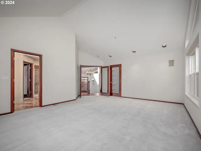 a spacious bathroom with a granite countertop sink a toilet and a mirror