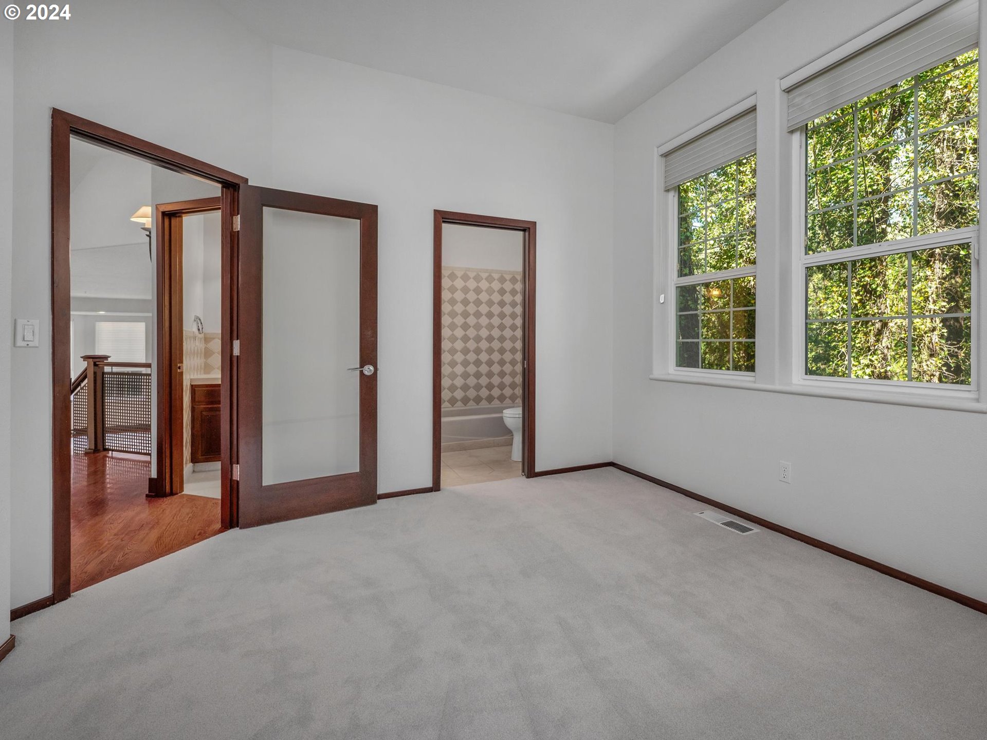 6254 Southwest Burlingame Avenue, Unit A Portland, OR 97239 - Photo 32 of 44 an empty room with windows and closet