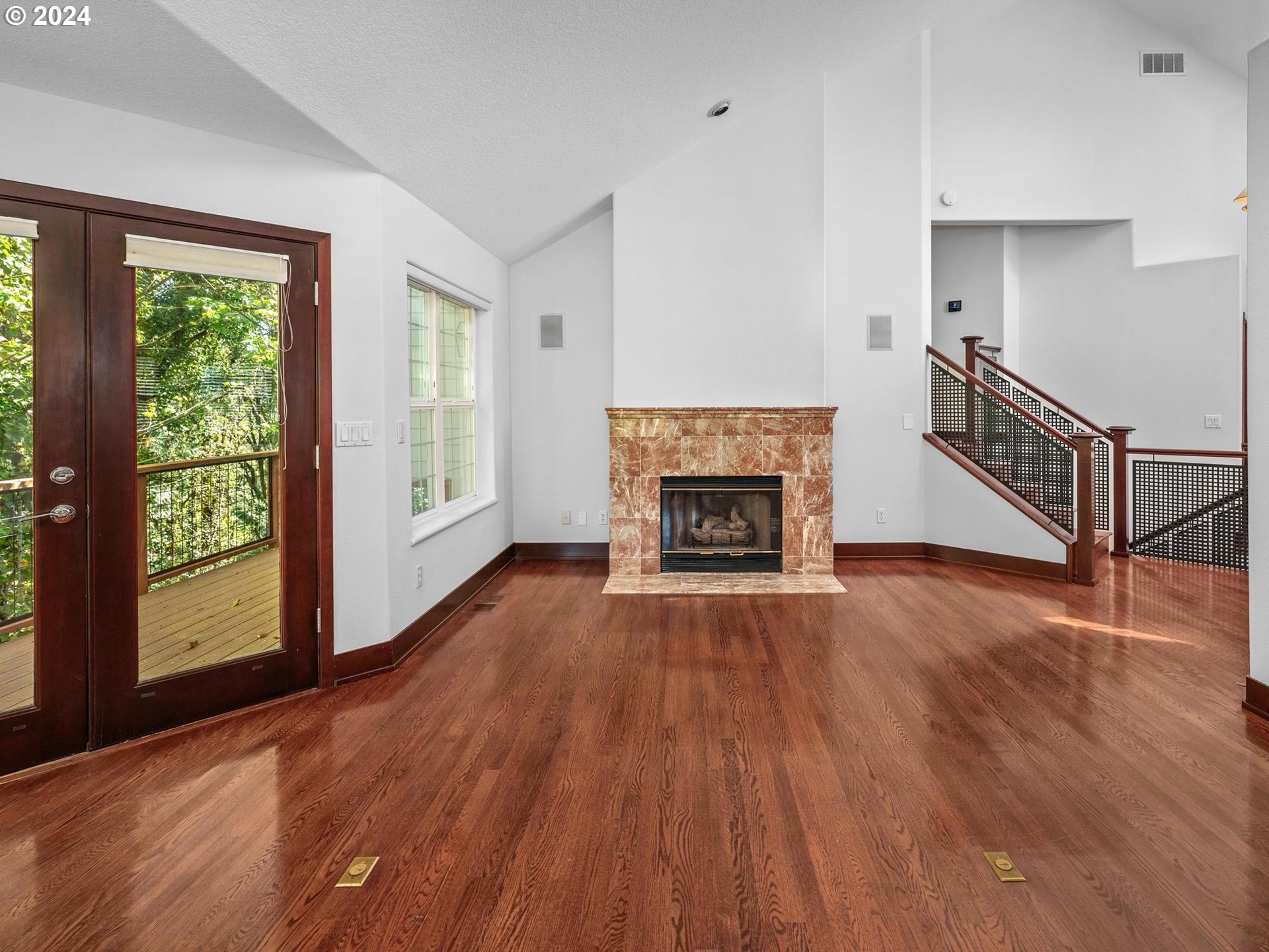 6254 Southwest Burlingame Avenue, Unit A Portland, OR 97239 - Photo 9 of 44 a room with wooden floors and a fireplace