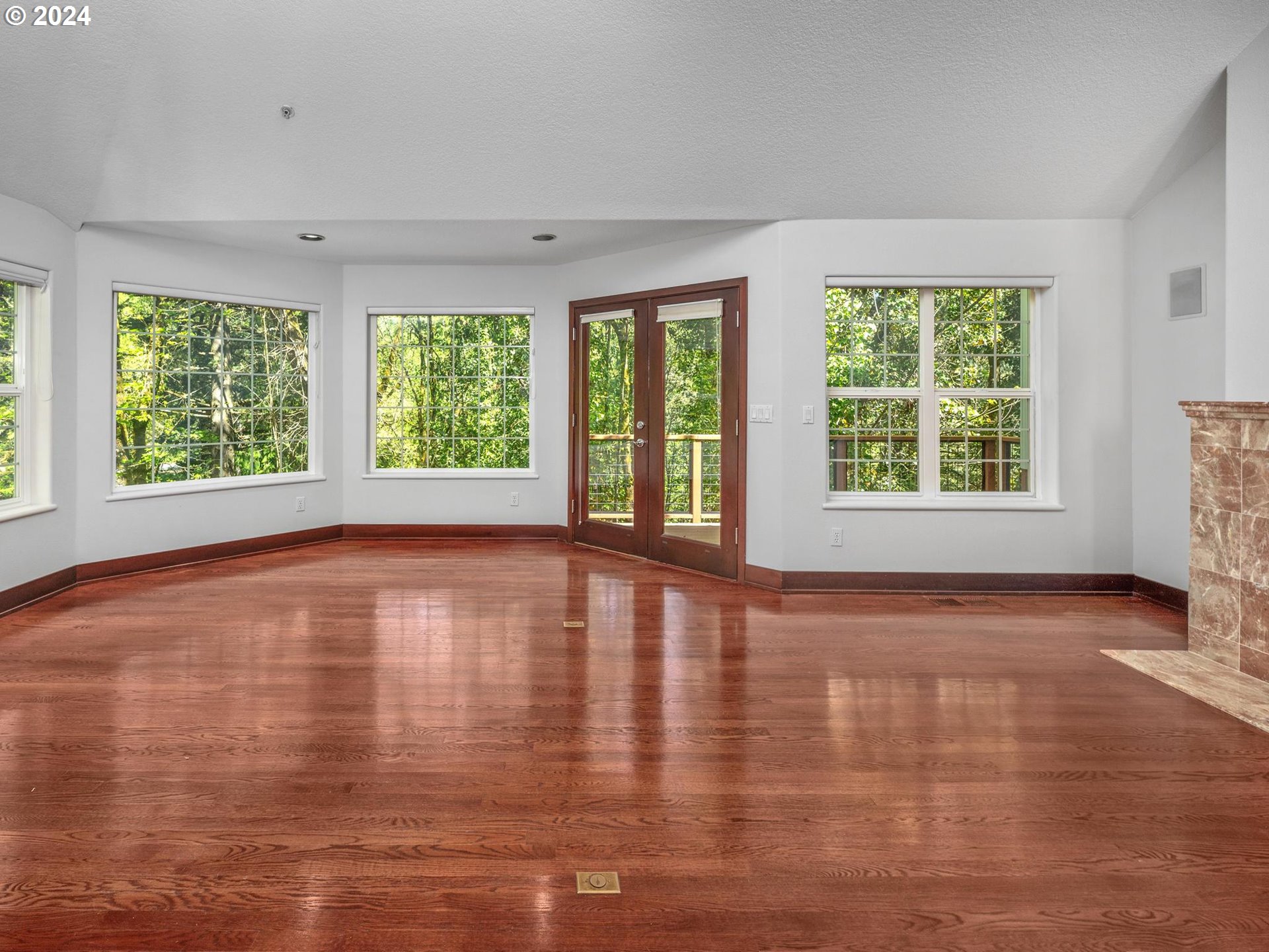 6254 Southwest Burlingame Avenue, Unit A Portland, OR 97239 - Photo 10 of 44 a view of an empty room with wooden floor and a window