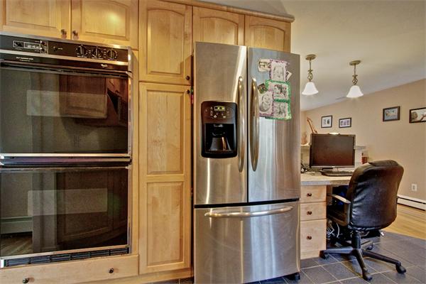 753 Potter Road Framingham, MA 01701 - Photo 8 of 25 a kitchen with stainless steel appliances a refrigerator stove and microwave