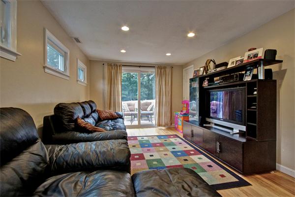 753 Potter Road Framingham, MA 01701 - Photo 10 of 25 a living room with furniture and a flat screen tv