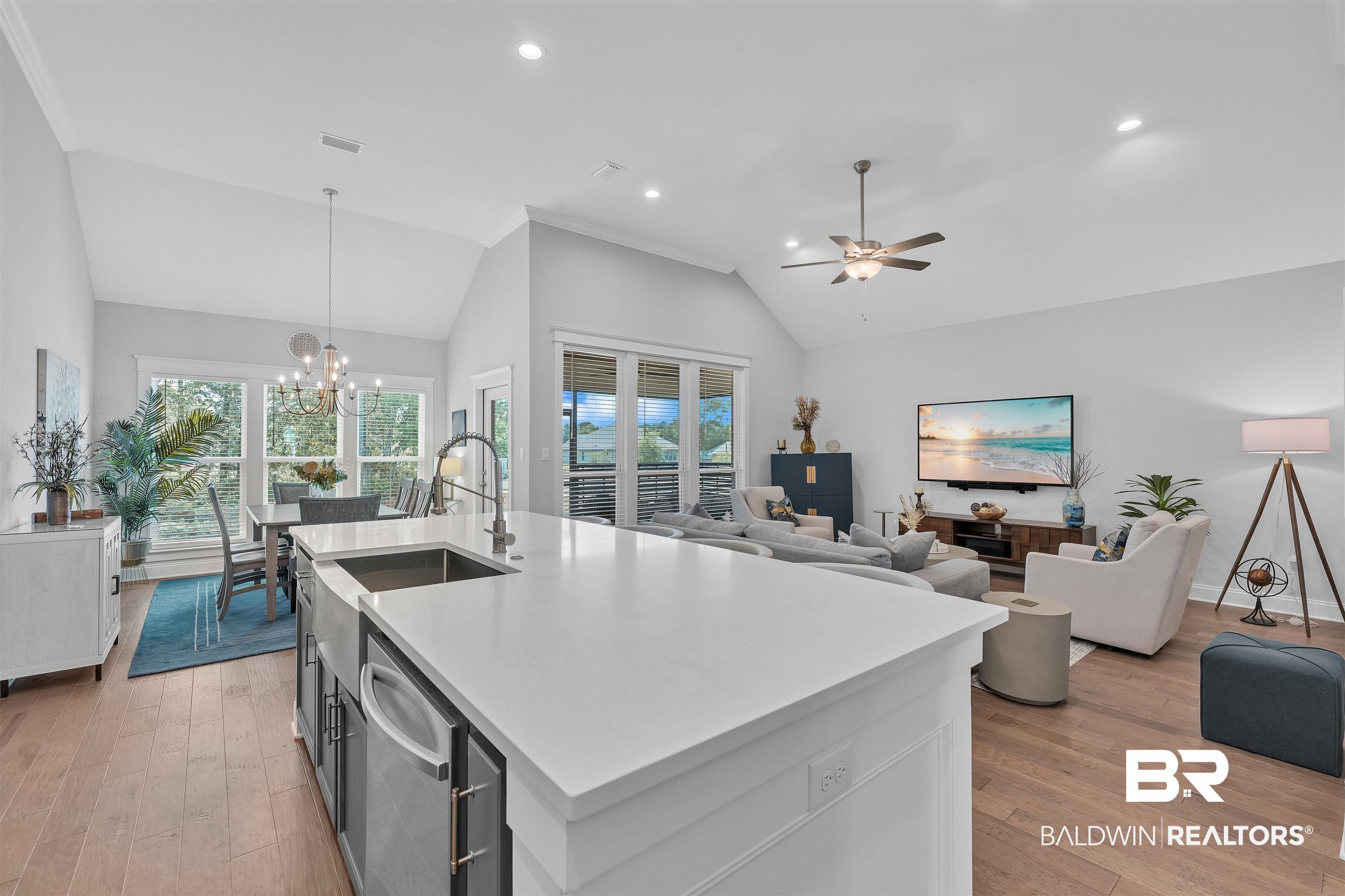 31630 Canopy Loop Daphne, AL 36527 - Photo 28 of 30 Kitchen with light wood finished floors, light countertops, ceiling fan with notable chandelier, open floor plan, and vaulted ceiling
