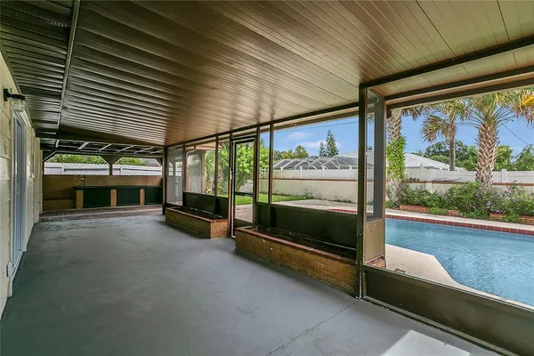 a view of a porch with furniture and a yard