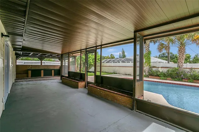 a view of a porch with furniture and a yard