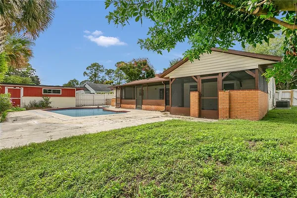 a backyard of a house with table and chairs