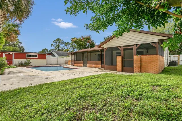 a backyard of a house with table and chairs