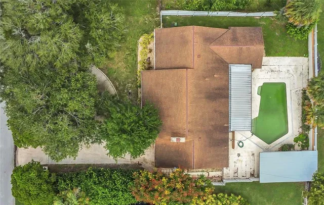 an aerial view of a house with a yard and a fountain