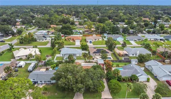 an aerial view of residential houses with outdoor space