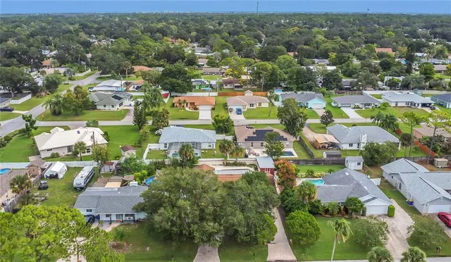 an aerial view of residential houses with outdoor space