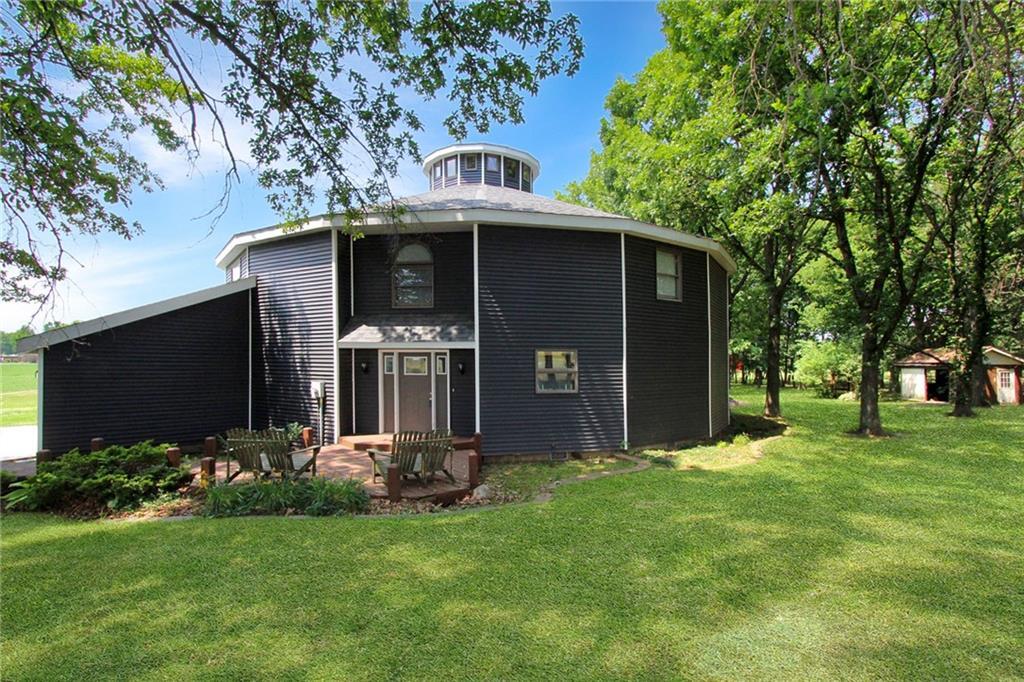 a front view of house with yard and trees in the background