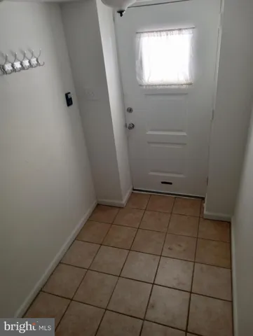 en empty room with window and chandelier fan