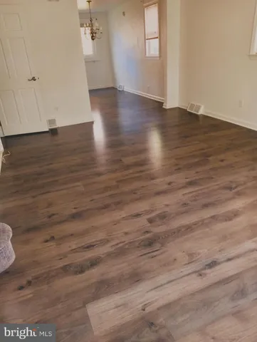 a view of wooden floor and a chandelier in a room