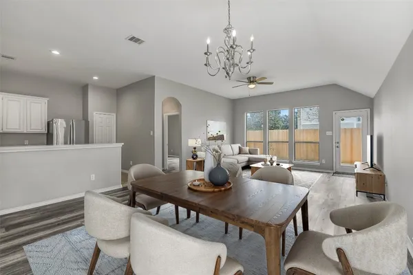 a view of a dining room with furniture wooden floor and chandelier