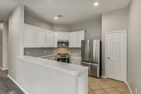 a kitchen with stainless steel appliances a refrigerator and a sink