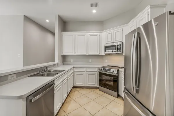 a kitchen with a sink stove and refrigerator