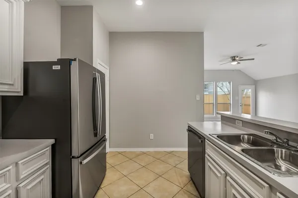 a kitchen with stainless steel appliances granite countertop a refrigerator and a sink