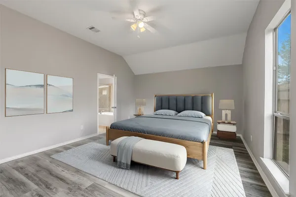 a bedroom with a bed and a ceiling fan