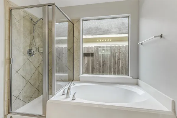 a bathroom with a bathtub and shower