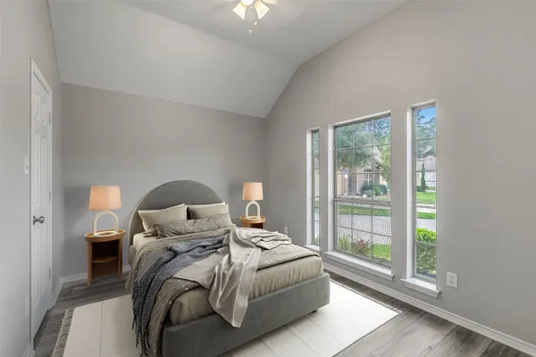 a bed room with a bed and a large window